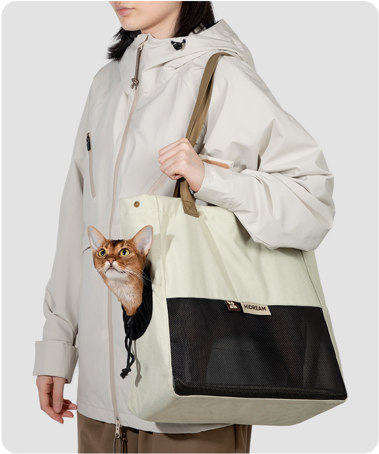 Almond Toast cat sling carrier in use with a cat