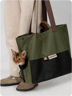 Cat enjoying an outdoor moment in the Matcha Cookie sling carrier
