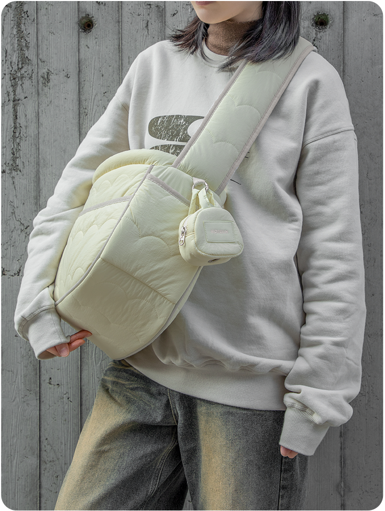Butter Pudding dog-walking poop bag pouch clipped to a crossbody bag