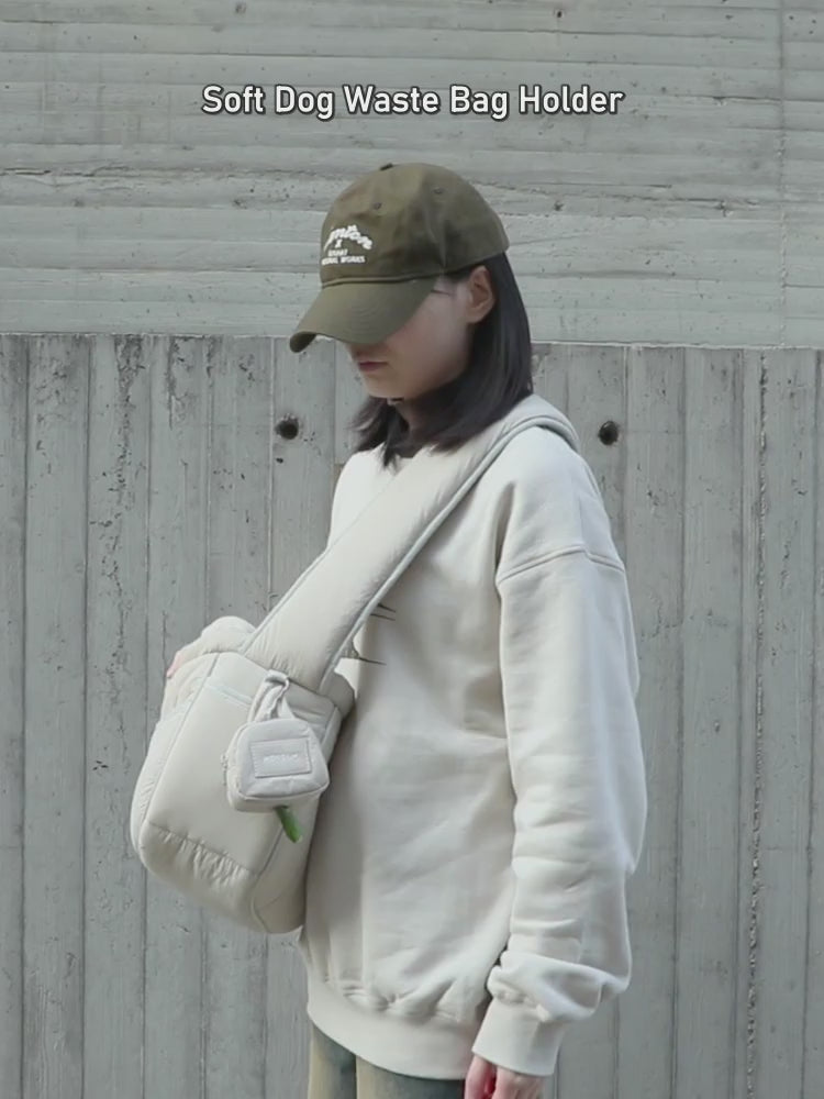 Soft dog-walking poop bag pouch in use on a dog walk